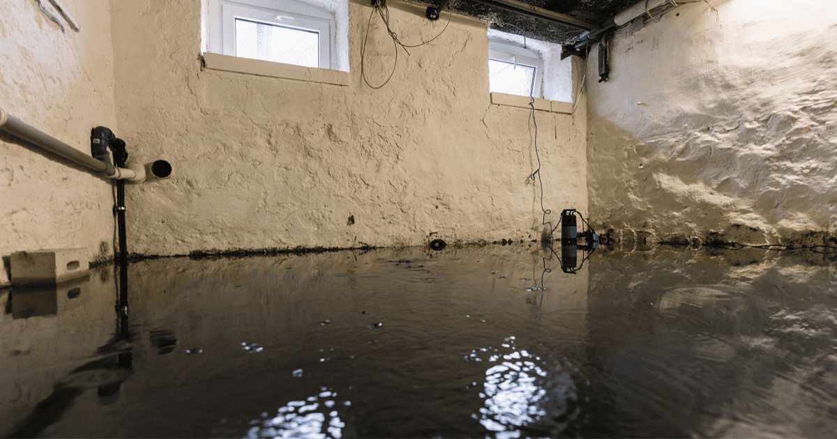 A flooded basement with water coming out of the windows.