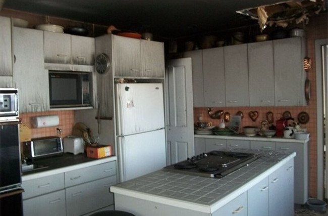 A kitchen with white cabinets and a white refrigerator