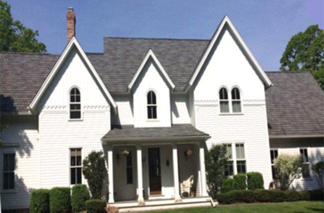 A large white house with a gray roof