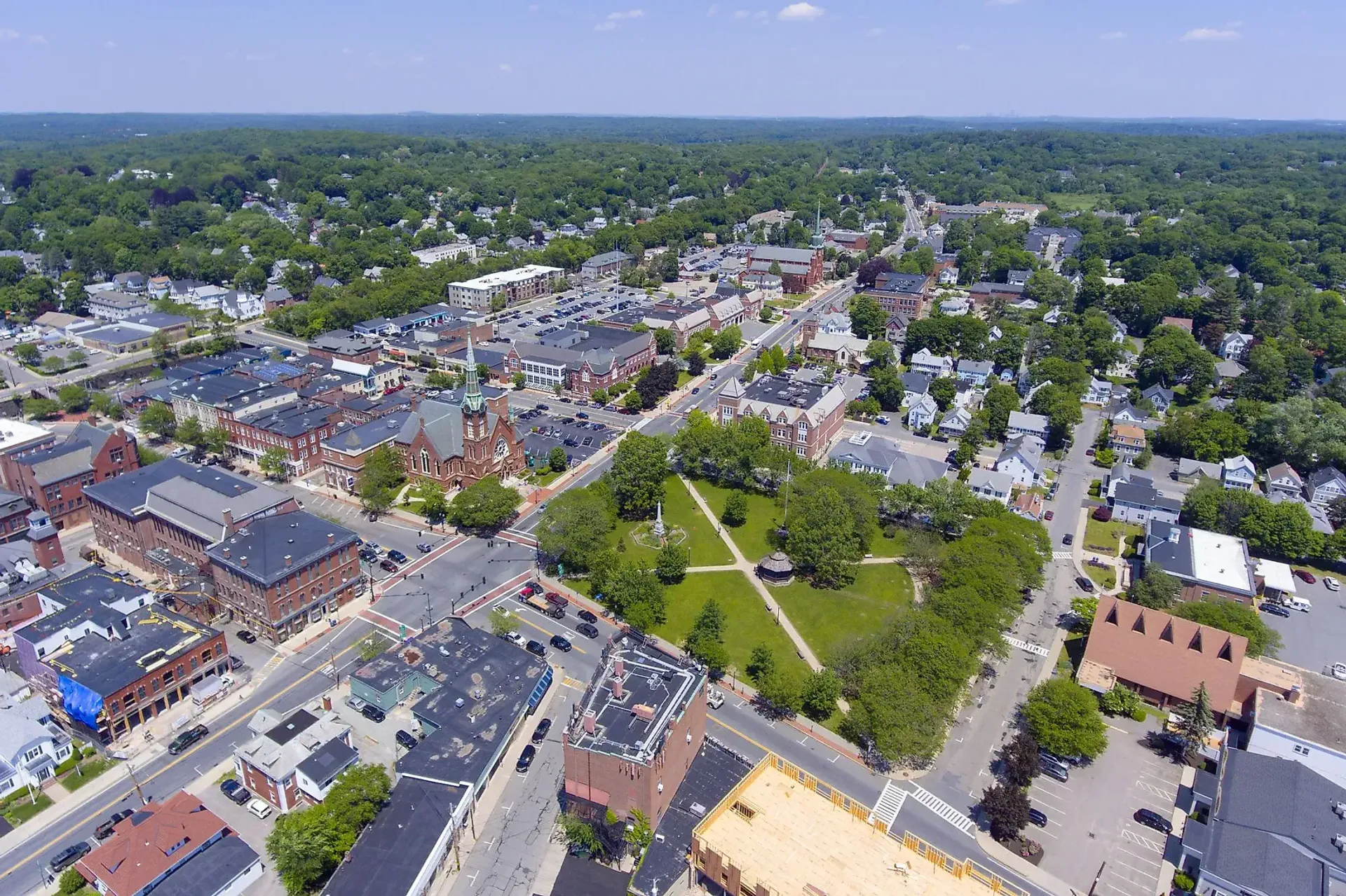 An aerial view of a small town surrounded by trees and buildings.