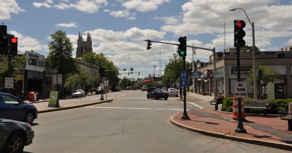 A city street with a red light on the right