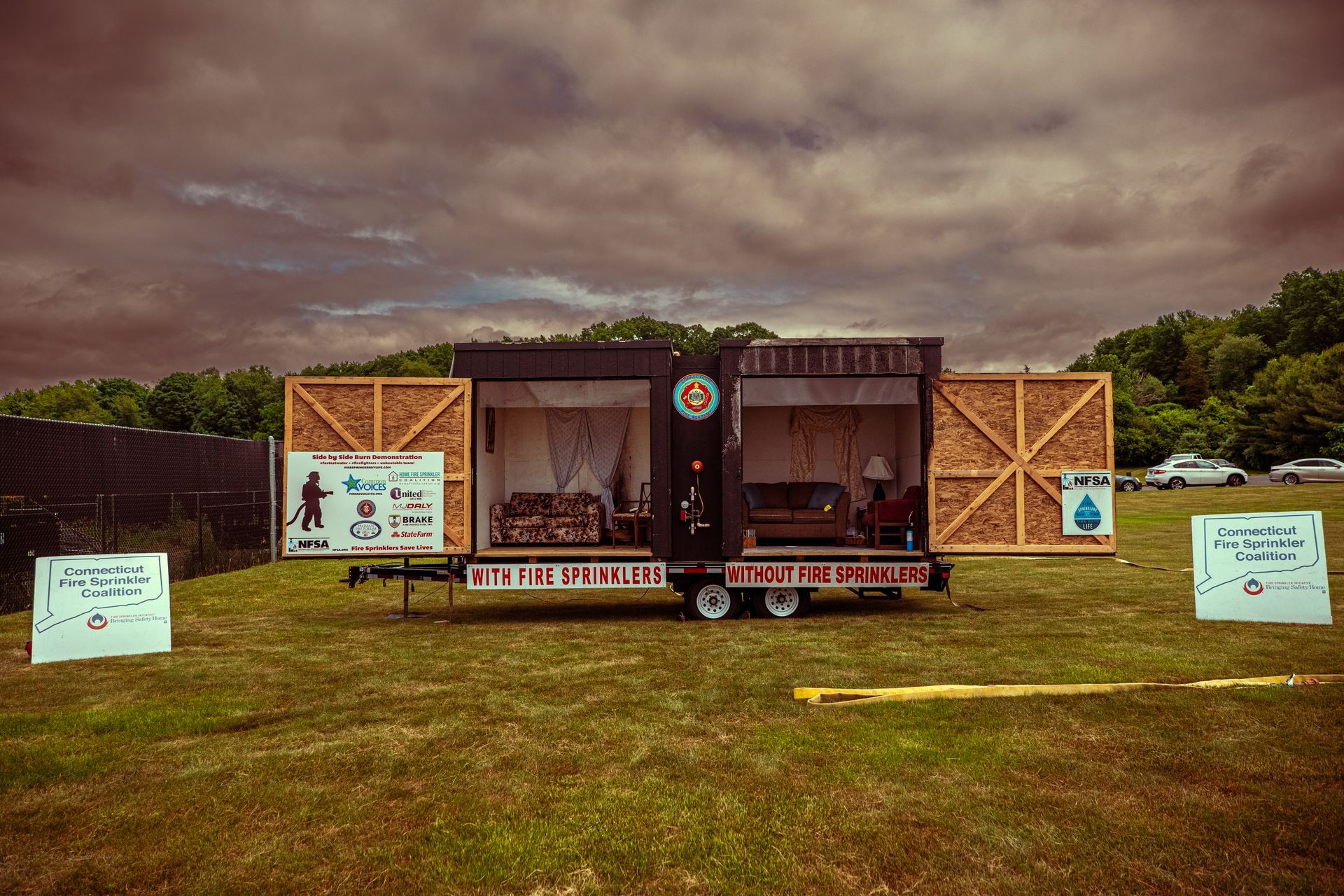 A trailer is parked in the middle of a grassy field.