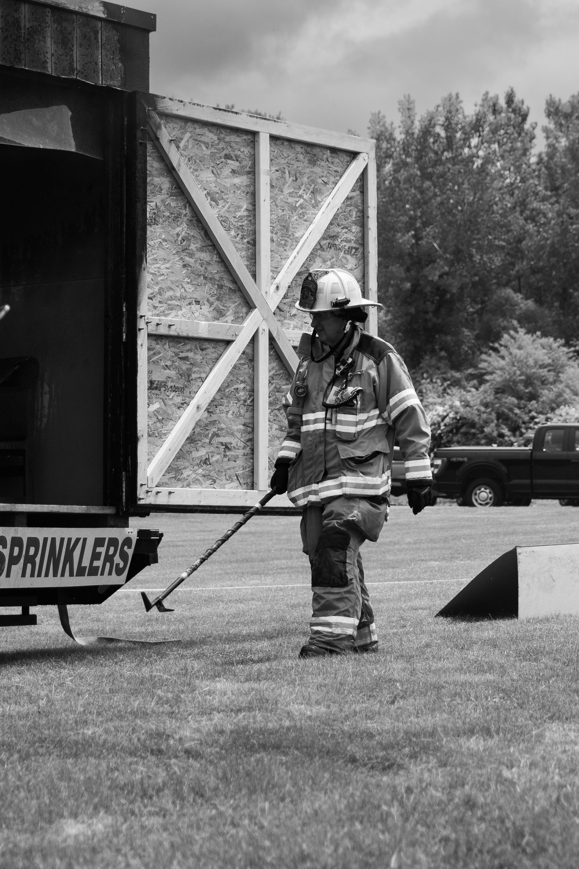 fireman preparing to hose a fire after live burn event