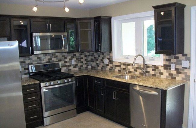 A kitchen with stainless steel appliances and granite counter tops