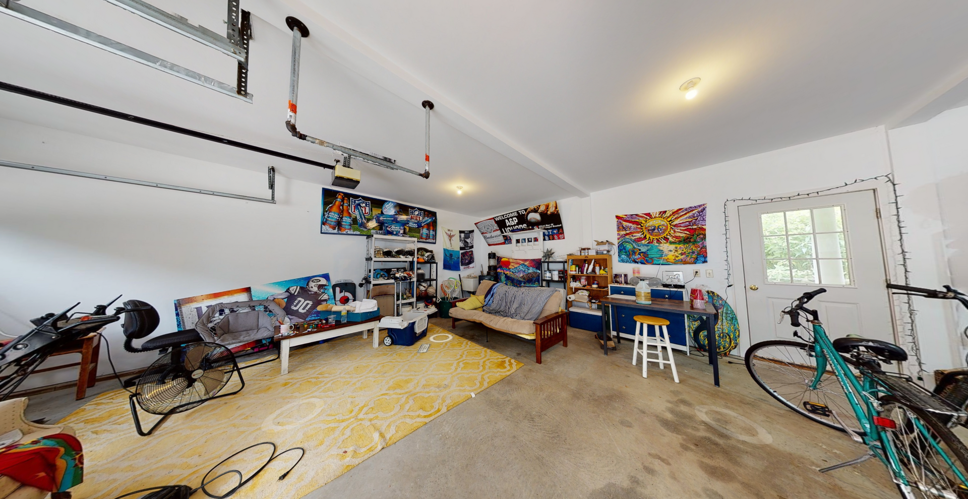 A garage with a lot of furniture and bikes in it.