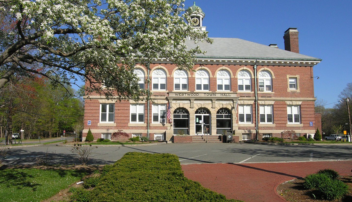 A large brick building with a tree in front of it