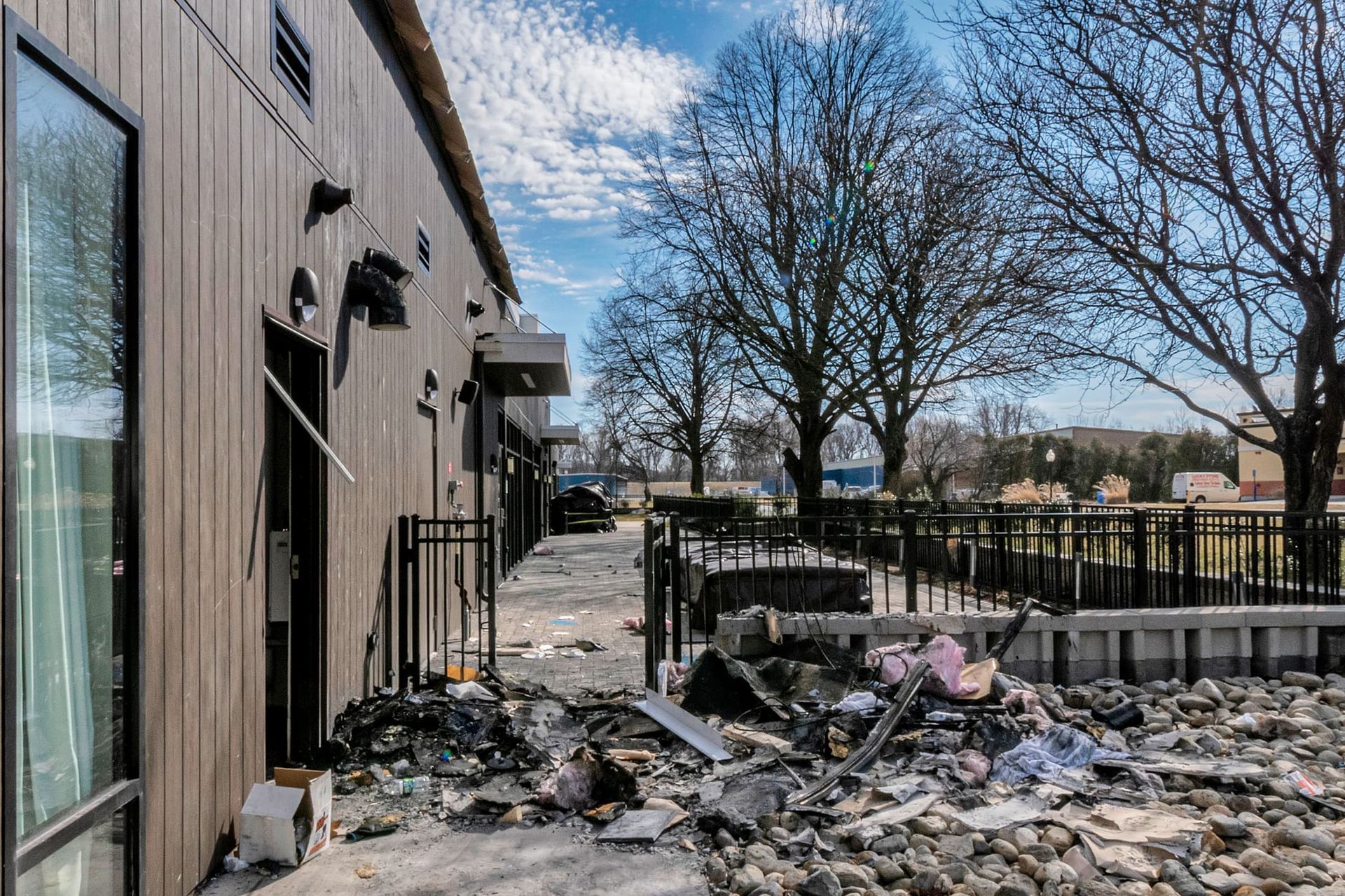 A building with a lot of trash on the ground in front of it.