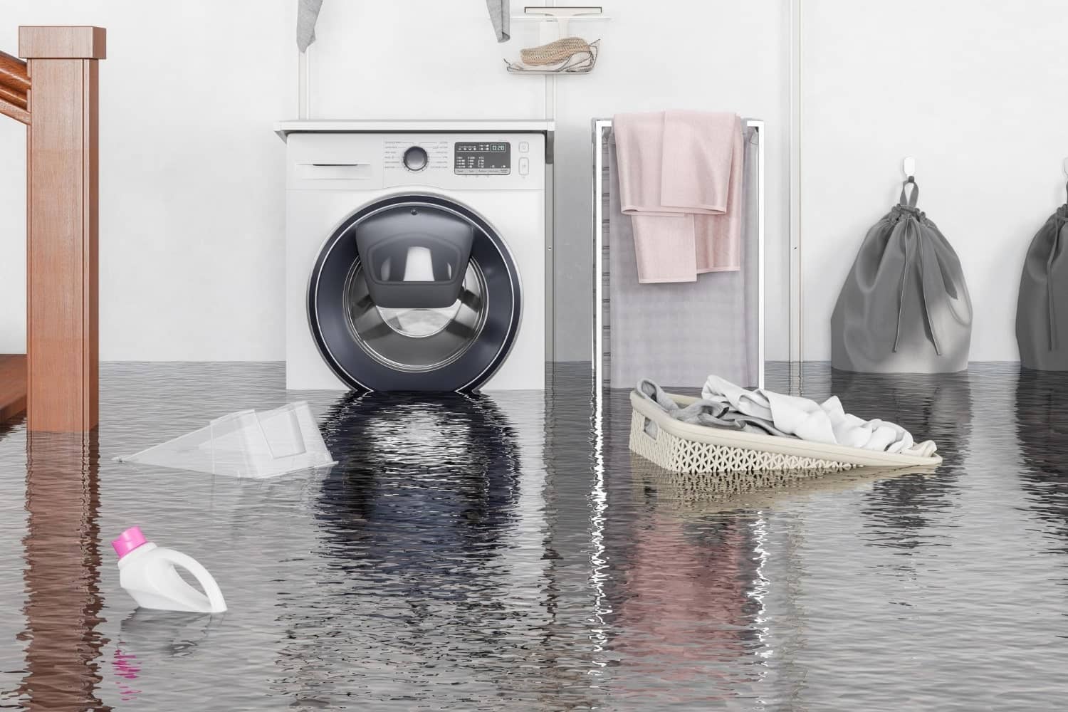 A washer and dryer are sitting in a flooded laundry room.