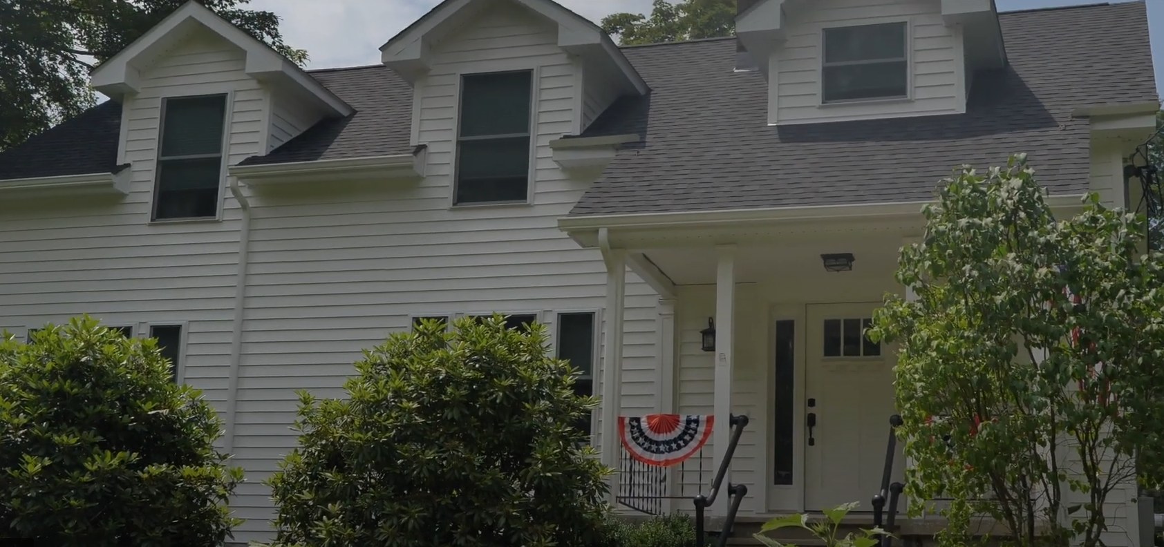 A woman is smiling in a black and white photo.