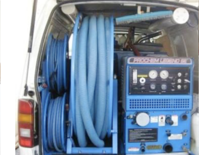 A blue machine is sitting in the back of a van