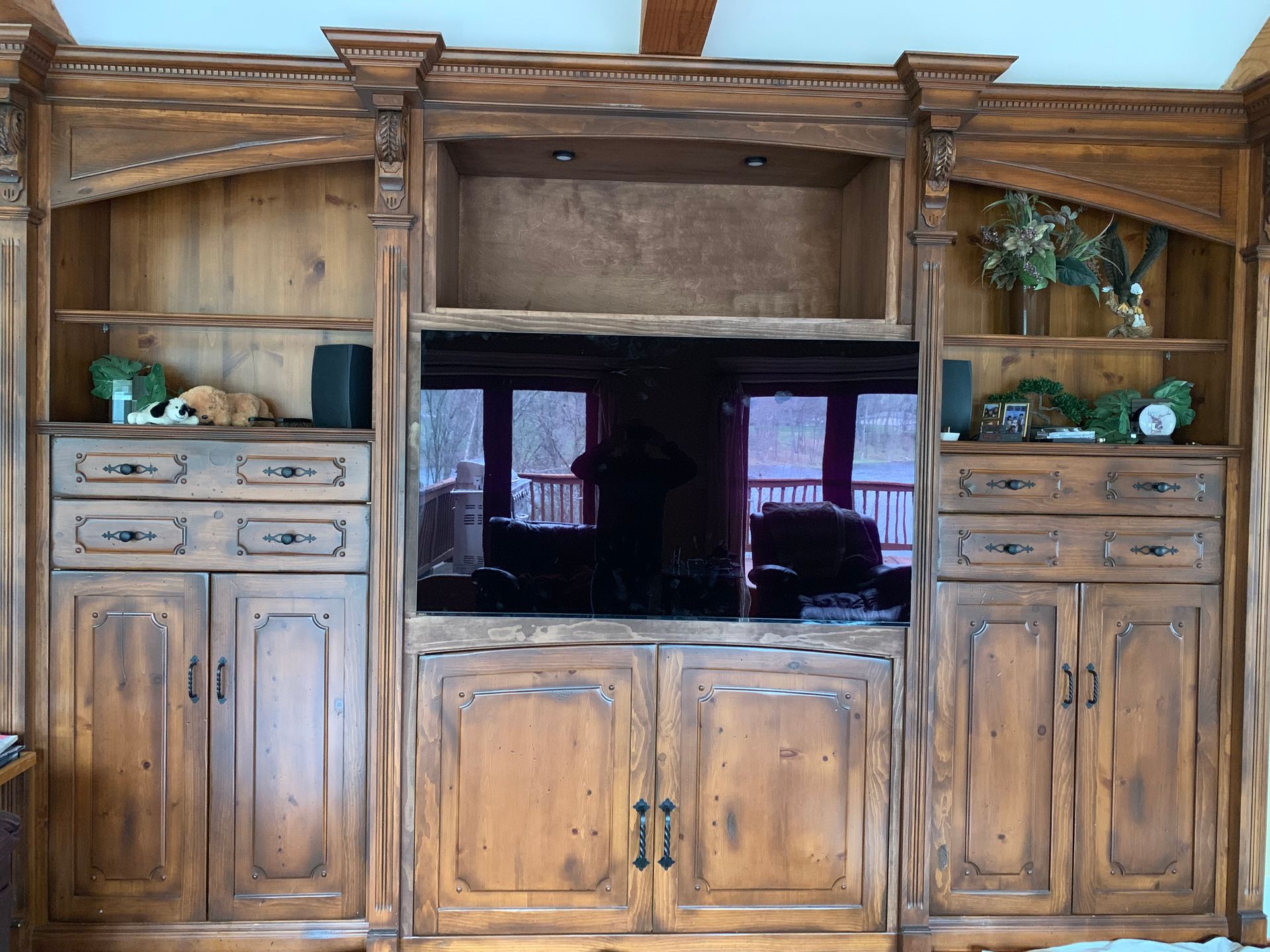 A Wooden Entertainment Center With a Flat Screen TV — Clarkston, Michigan — Hidden Lake Cabinet & Trim LLC