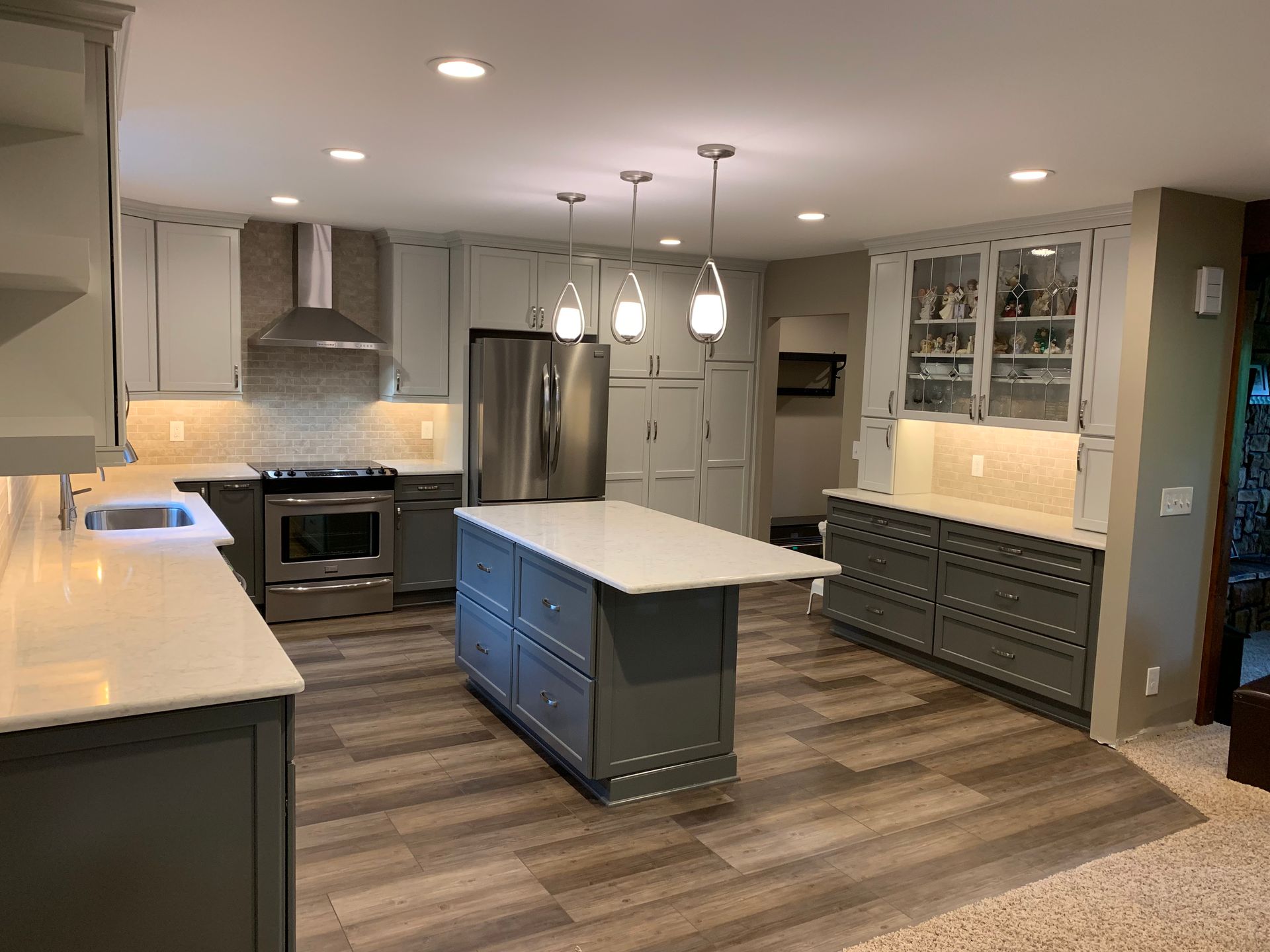 A Large Kitchen With a Large Island, and Stainless Steel Appliances — Clarkston, Michigan — Hidden Lake Cabinet & Trim LLC
