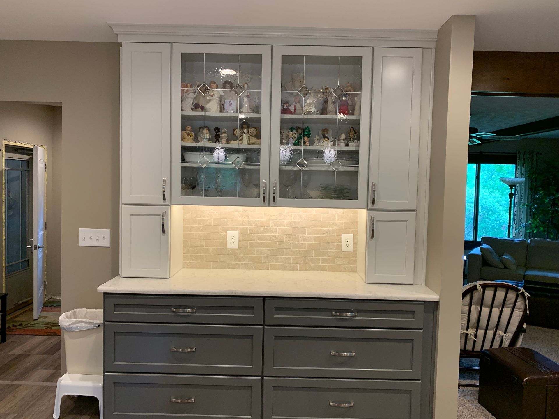 A Kitchen With White Cabinets and Gray Drawers and a Glass Door Hutch — Clarkston, Michigan — Hidden Lake Cabinet & Trim LLC