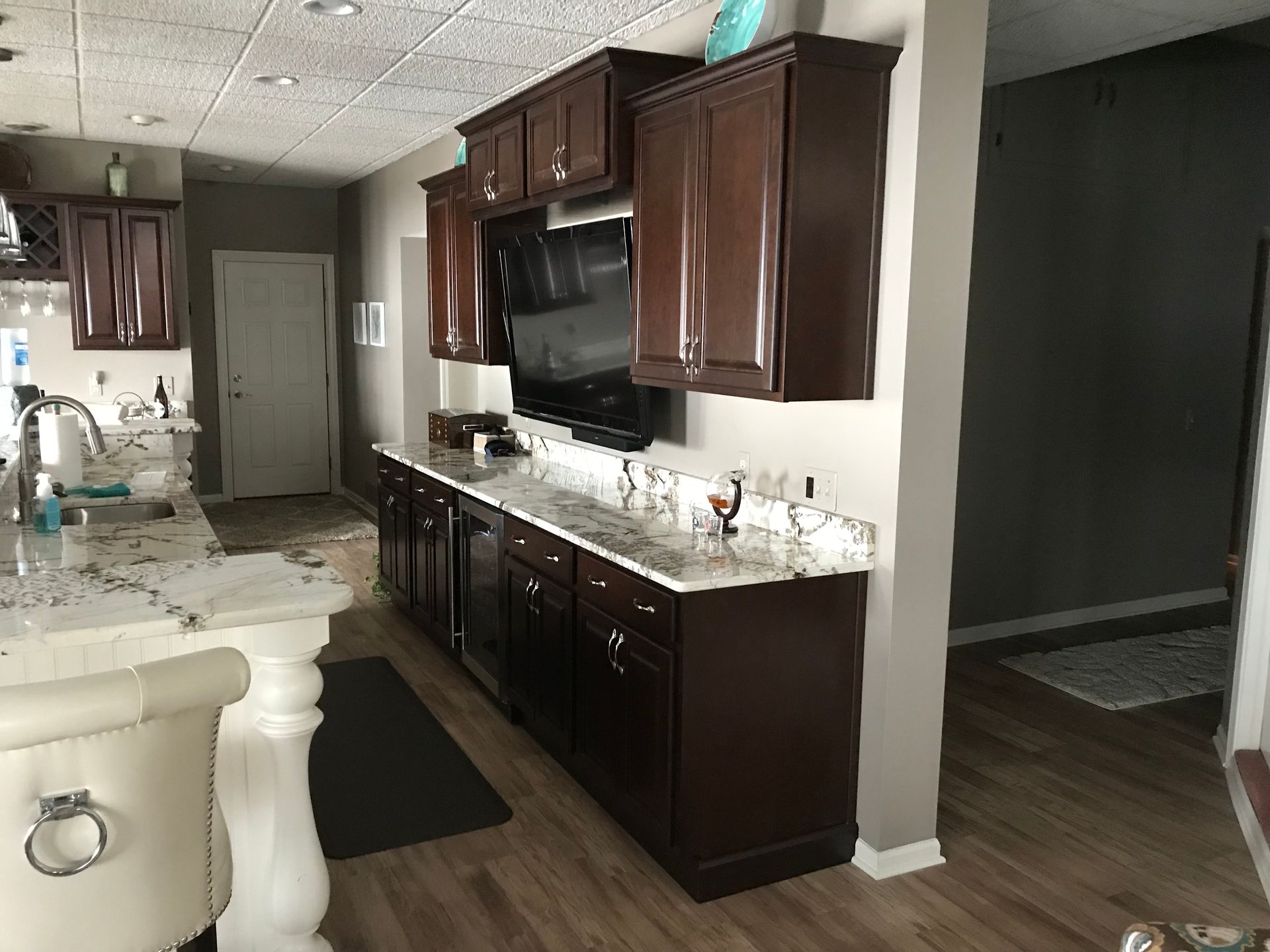 A Kitchen With Brown Cabinets and White Counter Tops — Clarkston, Michigan — Hidden Lake Cabinet & Trim LLC