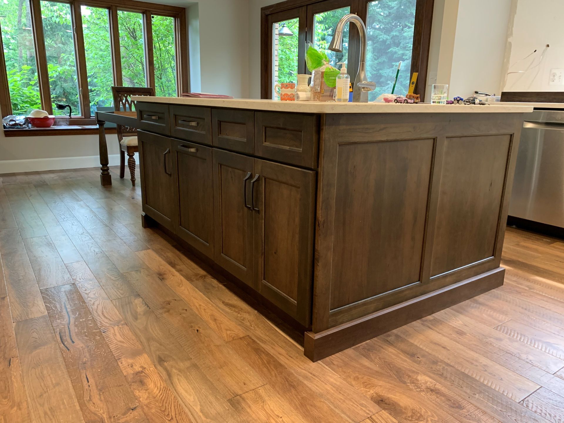 A kitchen with a large island and stainless steel appliances.