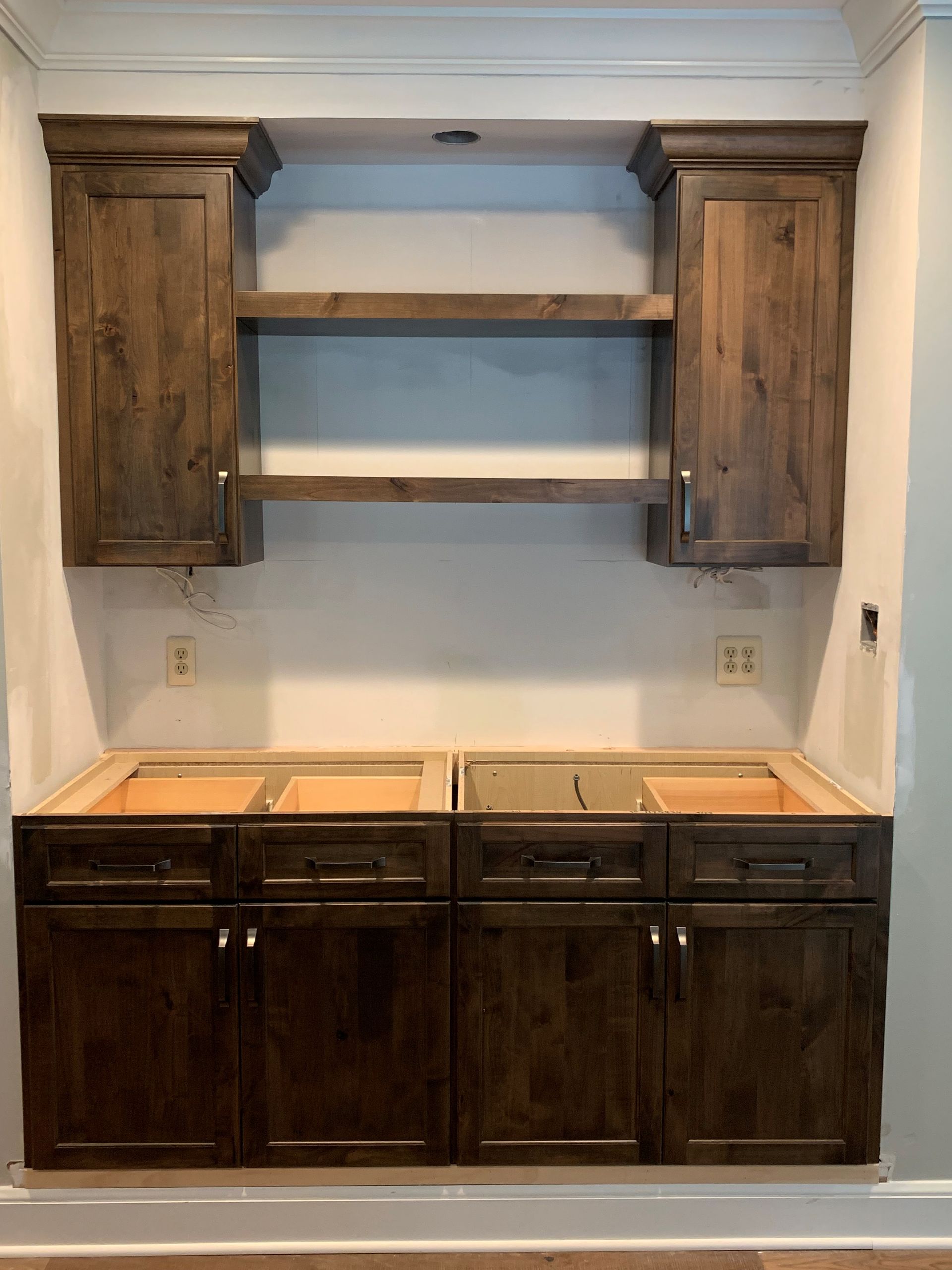 A kitchen with wooden cabinets and a sink.