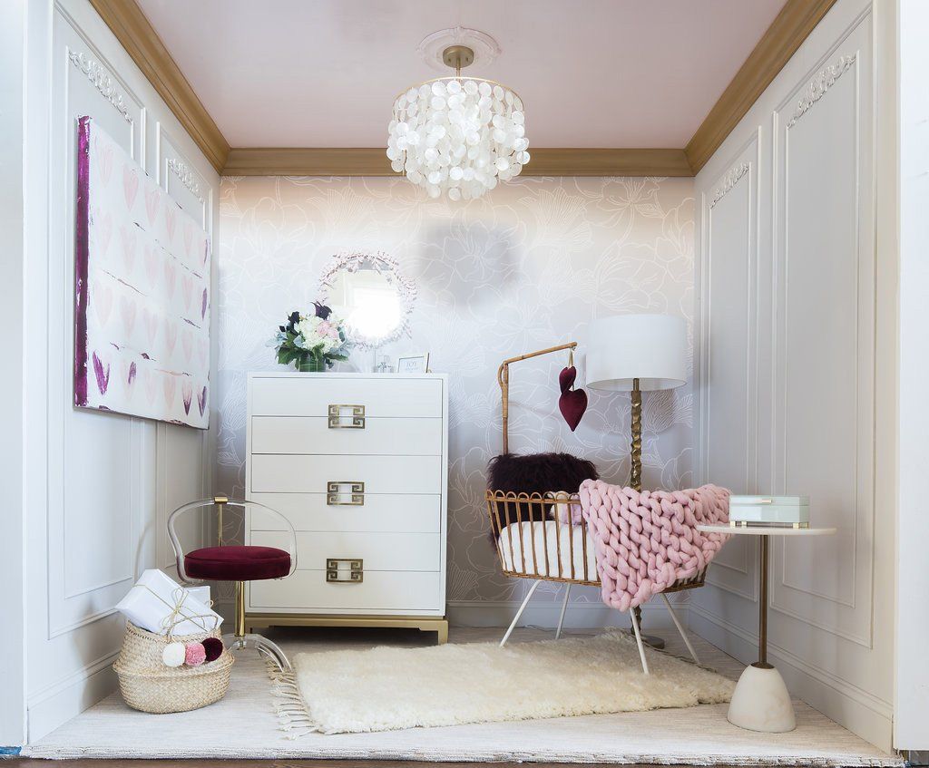 Baby nursery with white furniture, gold accents, pink and white decor.