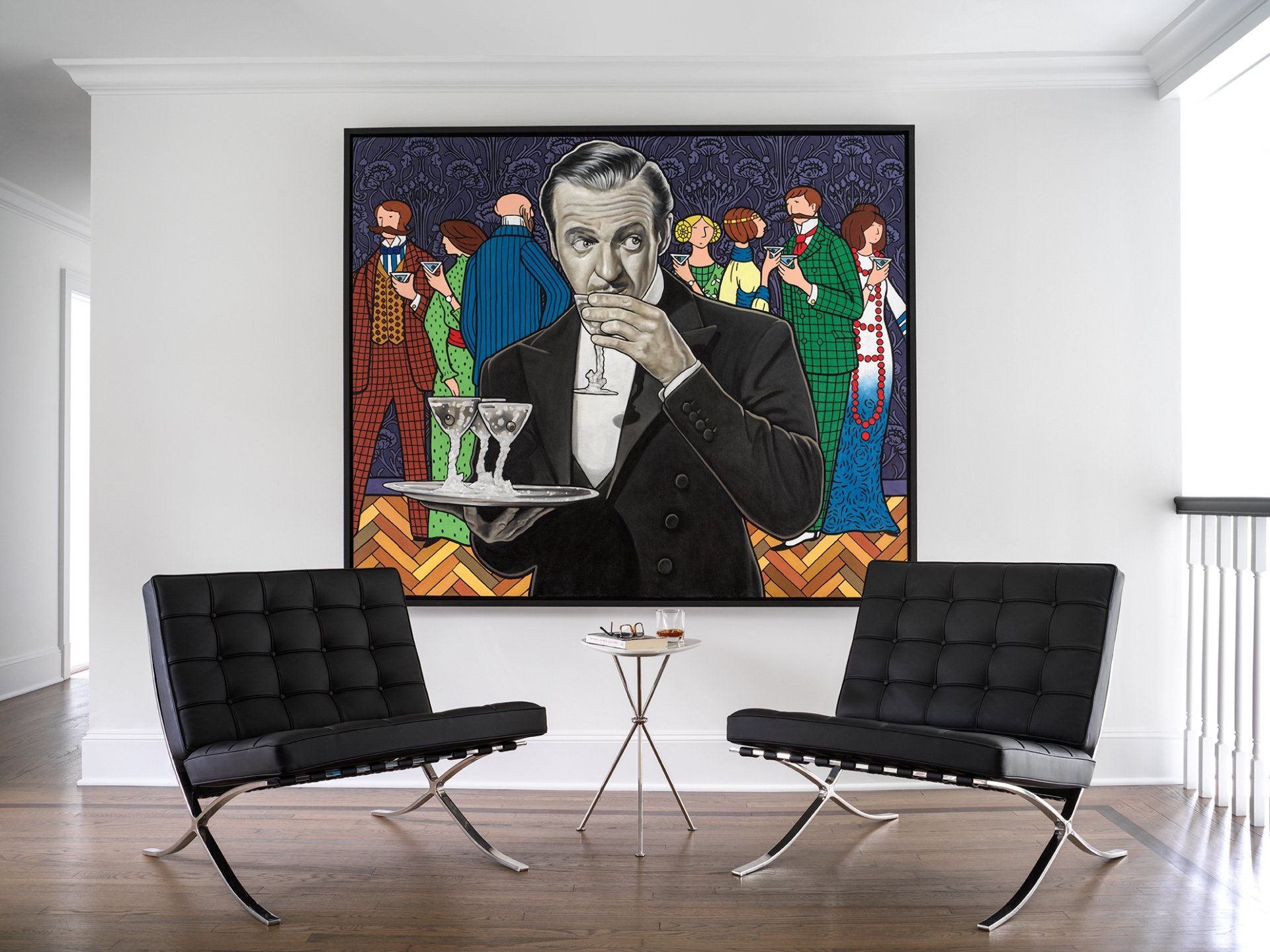 Black chairs facing a large artwork of a waiter holding a tray; white walls, wooden floor.
