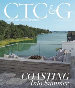 Magazine cover, Connecticut Cottages & Gardens, June 2016. Waterfront patio with a fire pit, overlooking the ocean. 