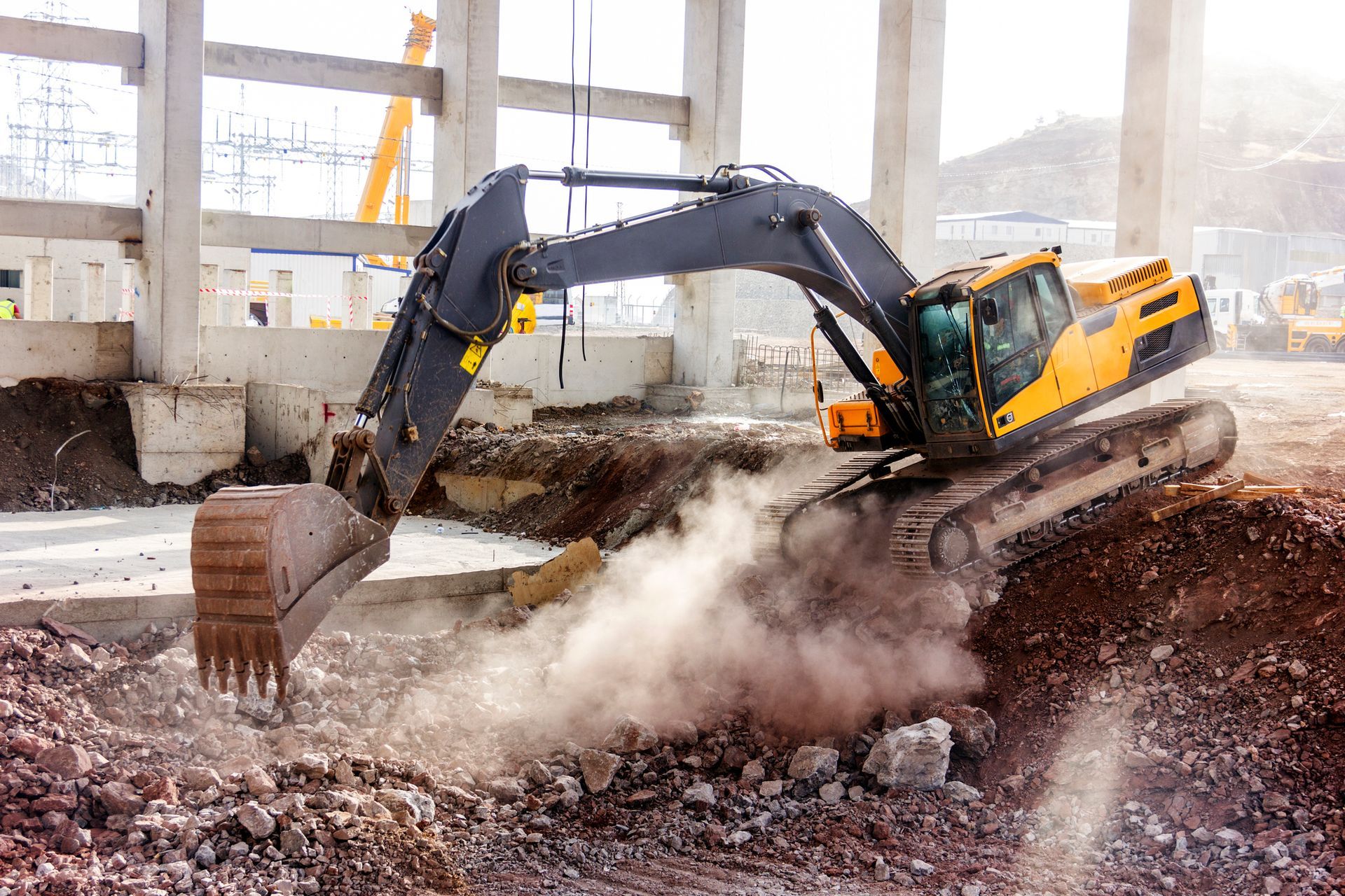 An excavator is digging a hole in a construction site – West Mifflin, PA - CTS Construction-Excavation, Inc.