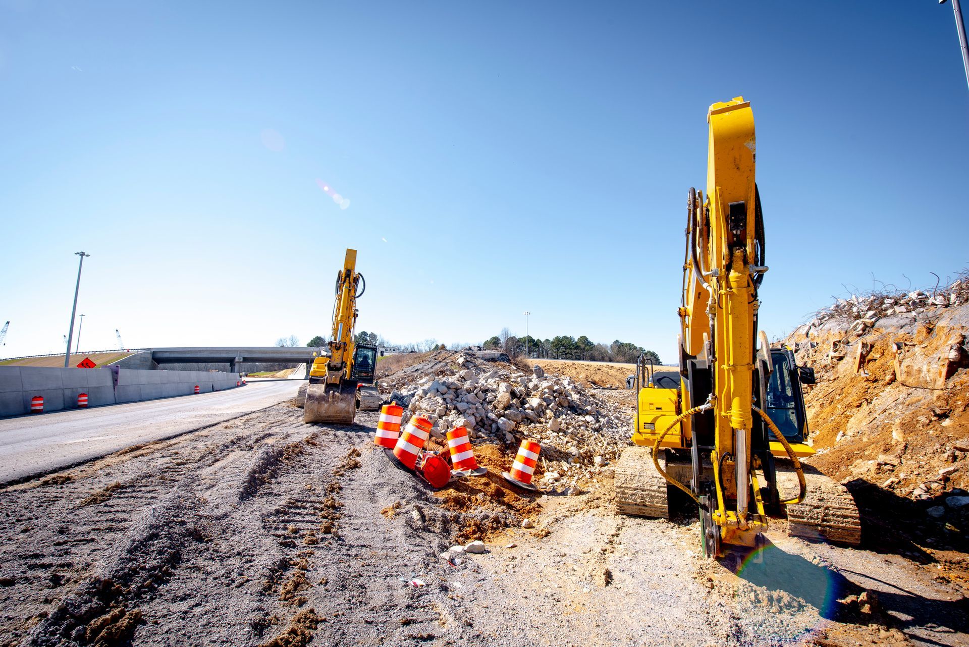 Two yellow excavators are working on a construction site – West Mifflin, PA - CTS Construction-Excavation, Inc.