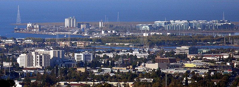 An aerial view of a city with the ocean in the background