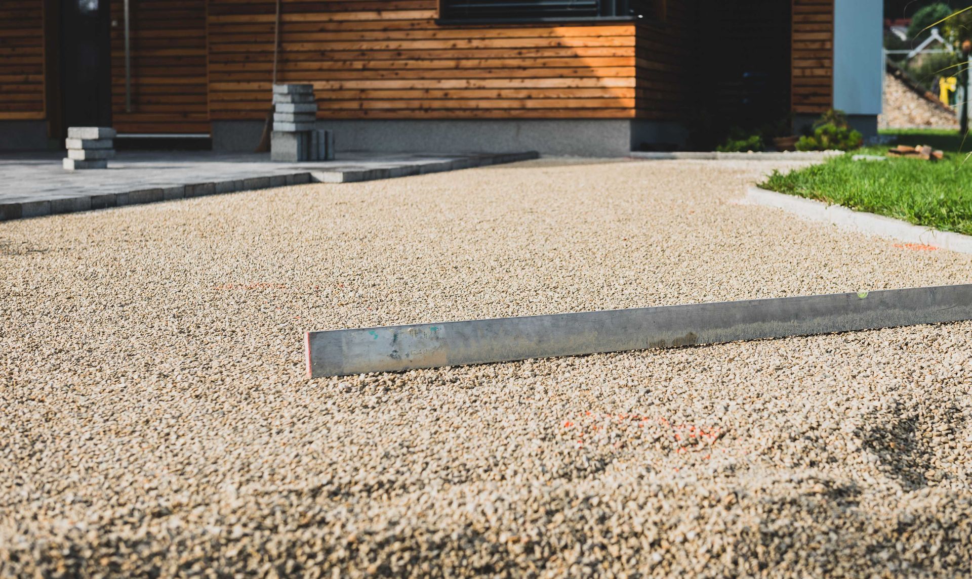 concrete paving slab patio being leveled next to house