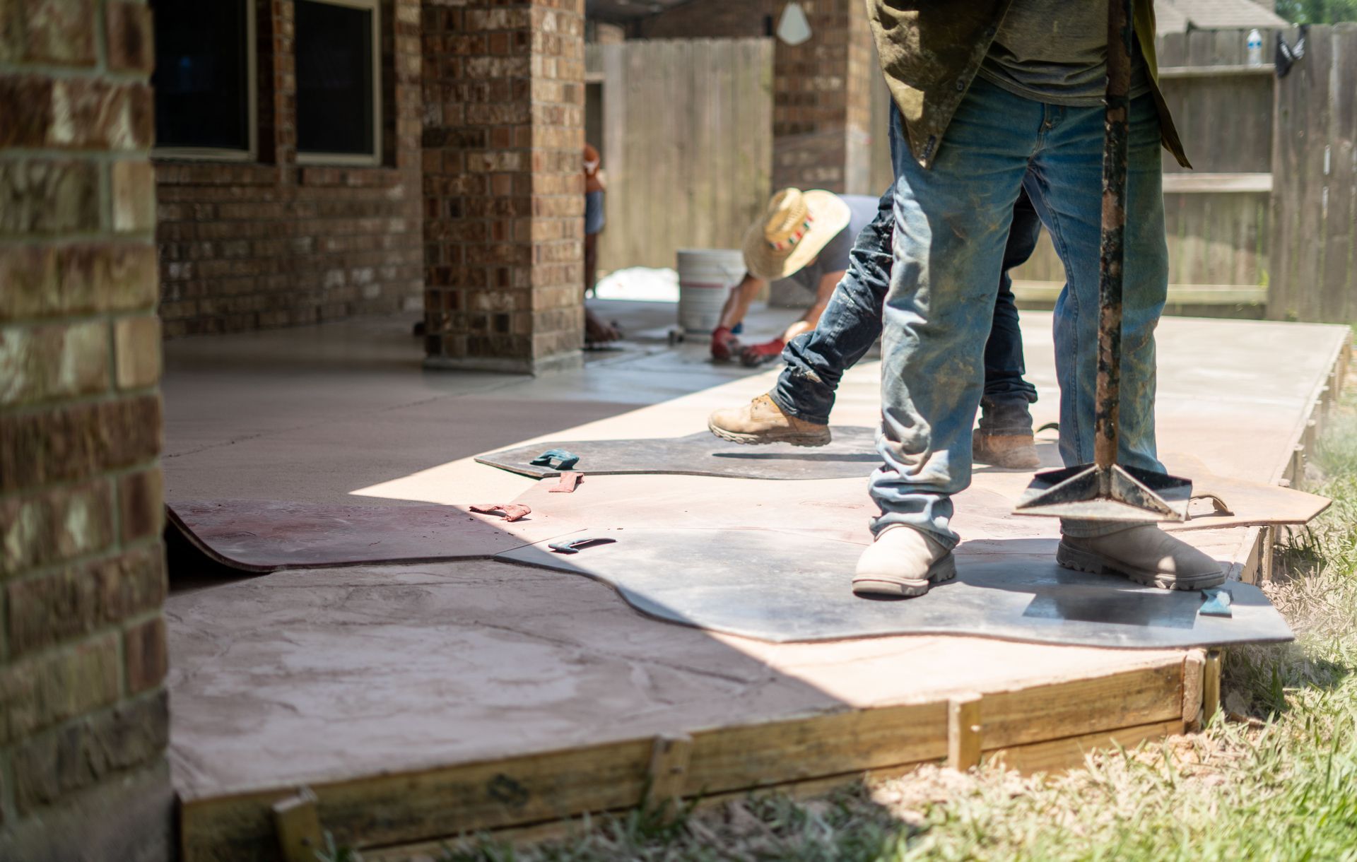 workers apply stamped concrete to patio Durham NC