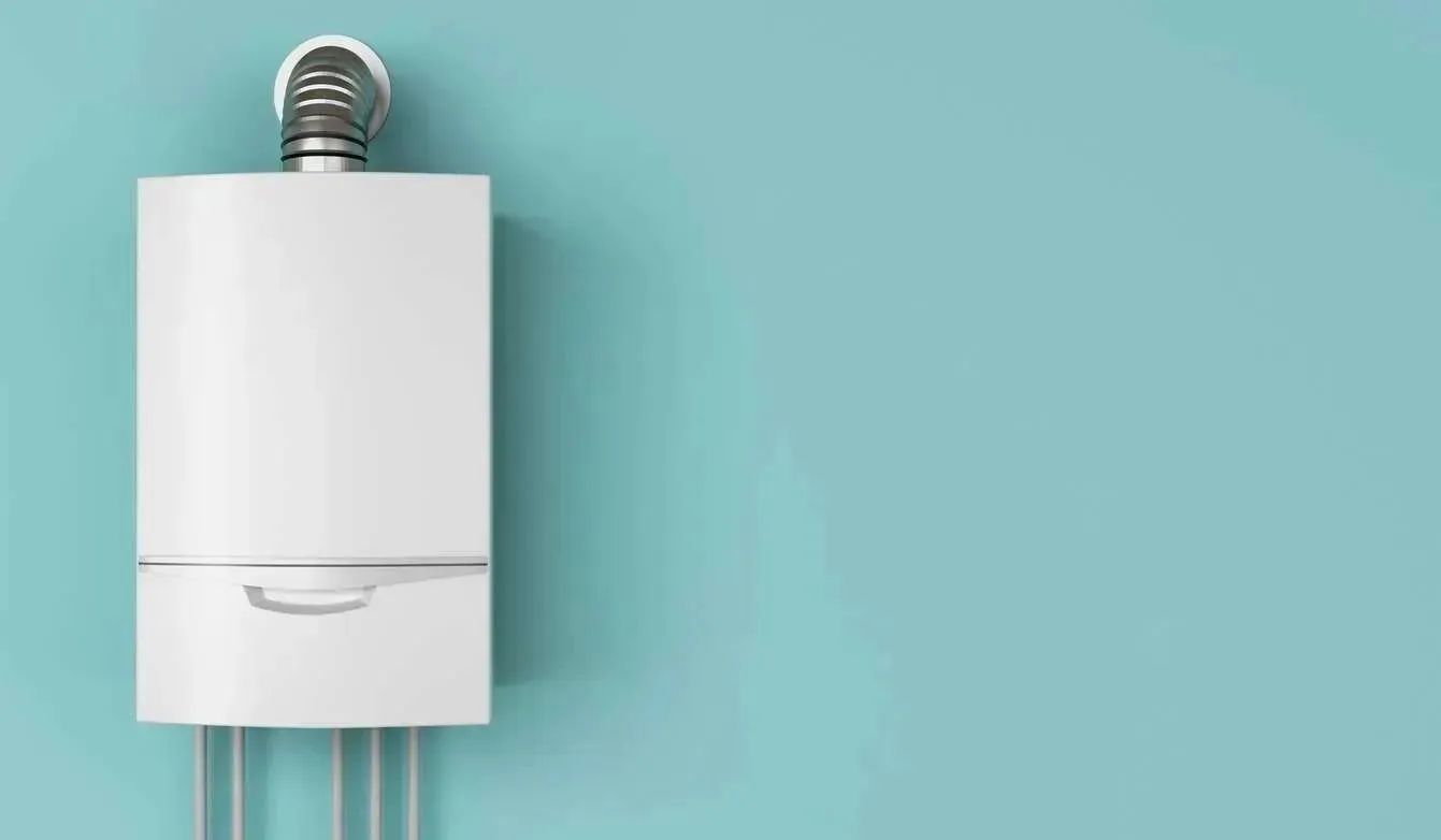 A modern white boiler mounted on a blue wall, featuring a chimney pipe and three connected pipes at the bottom.