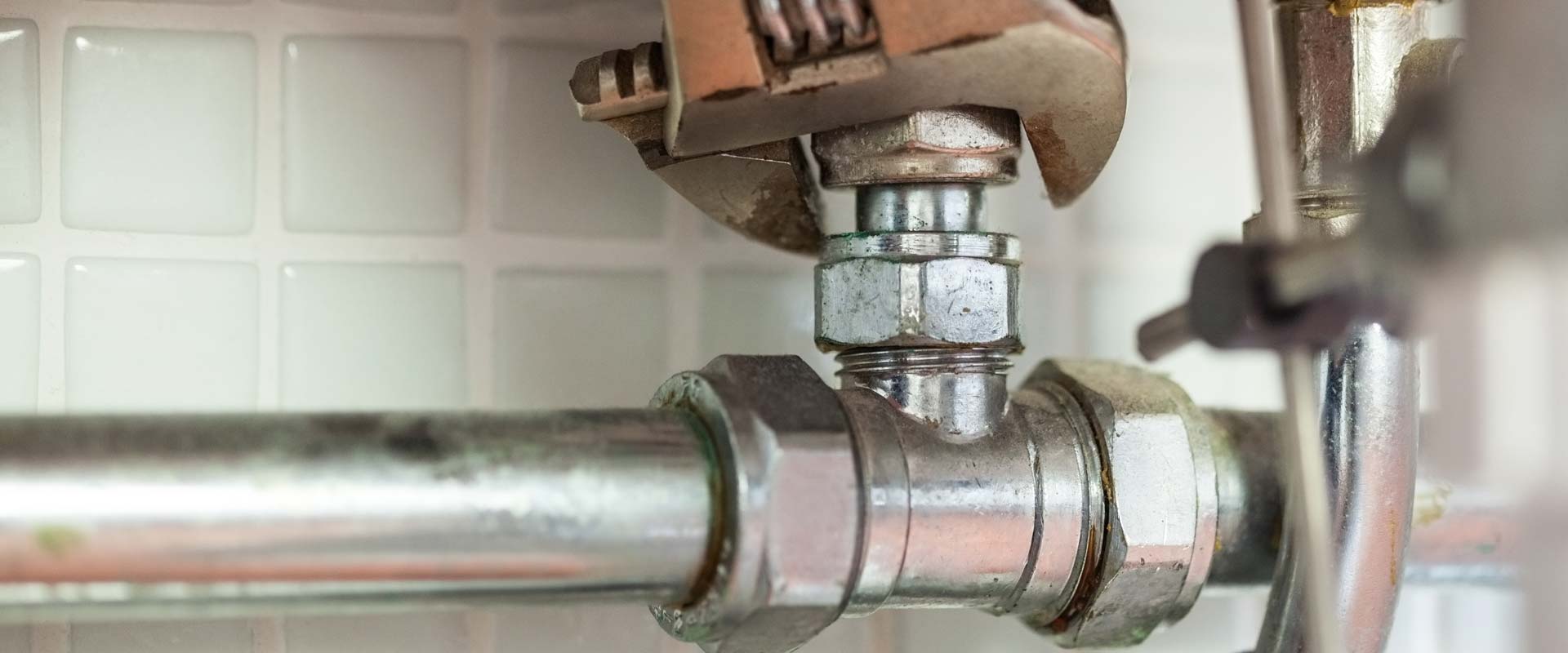 Close-up of a pipe being fixed by a plumber