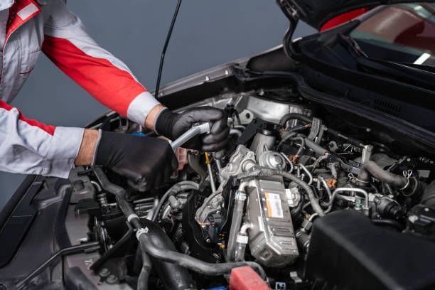 A Mechanic Is Working On The Engine Of A Car — Transtate Trailers & 4wd In Belconnen, ACT