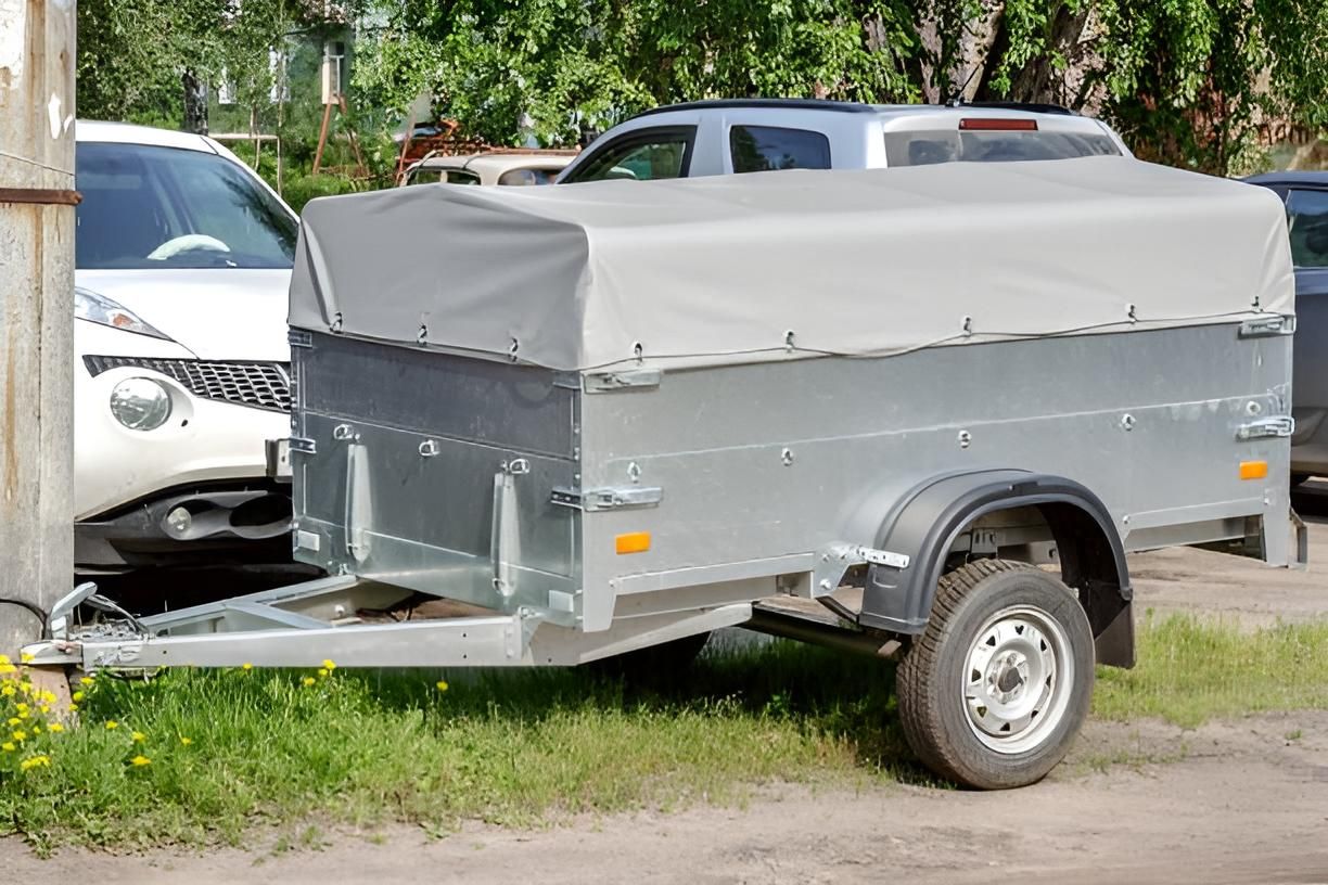 A Trailer With A Canopy Is Parked Next To A Car In A Parking Lot — Transtate Trailers & 4wd In Belconnen, ACT