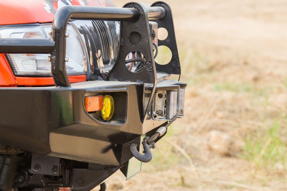 A Close Up Of The Front Bumper Of A Truck In A Field — Transtate Trailers & 4wd In Belconnen, ACT