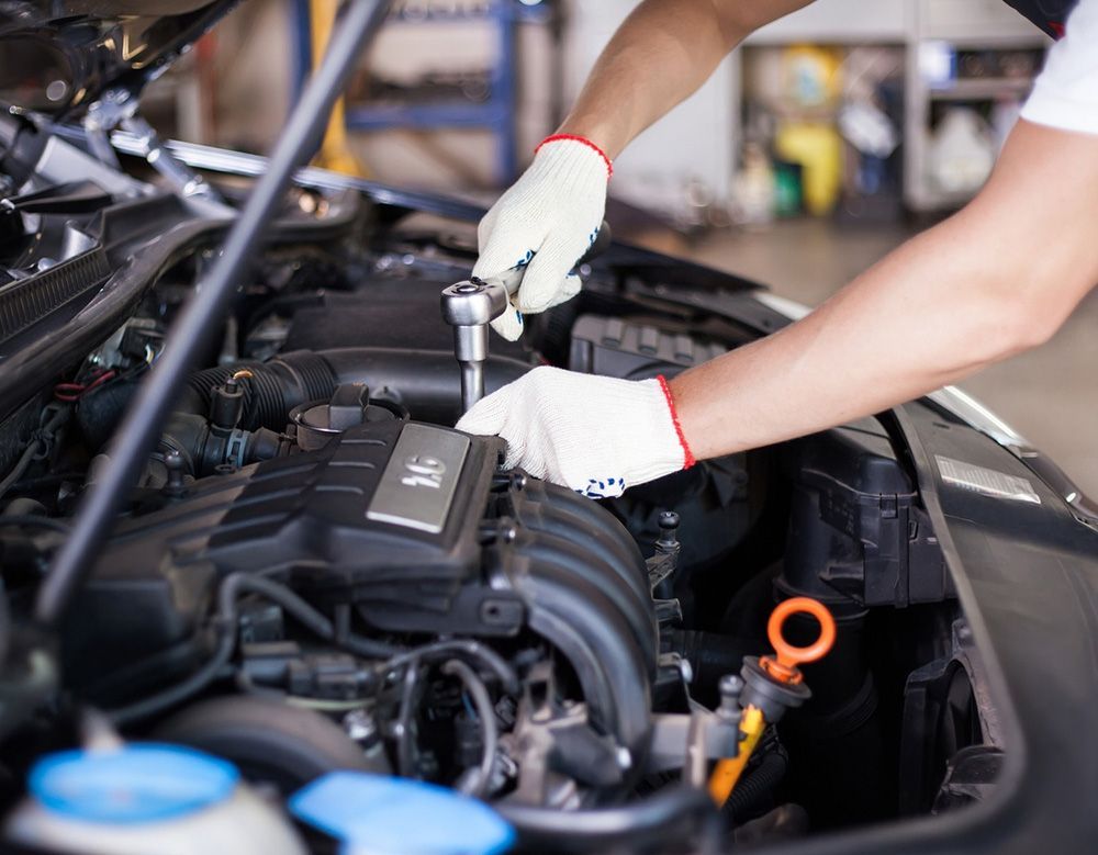 Mechanic Working on a Car Engine with Gloves, Using a Wrench — Transtate Trailers & 4wd In Belconnen, ACT