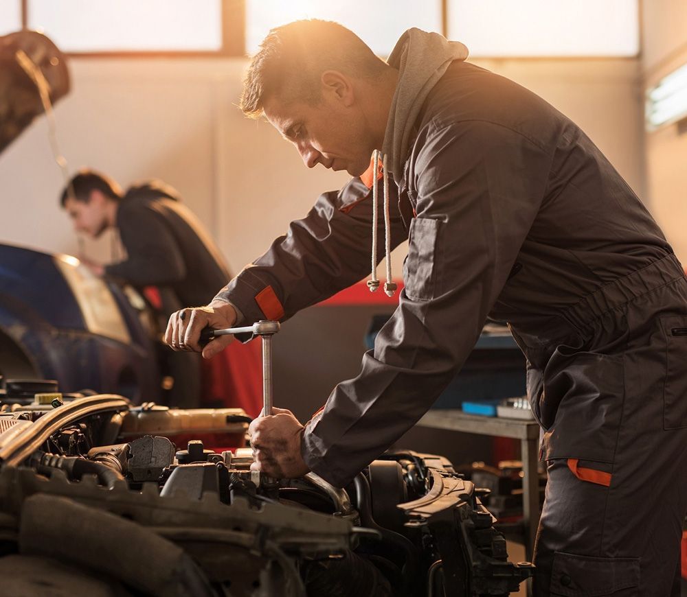 Mechanic Working on a Car Engine in a Garage — Transtate Trailers & 4wd In Belconnen, ACT