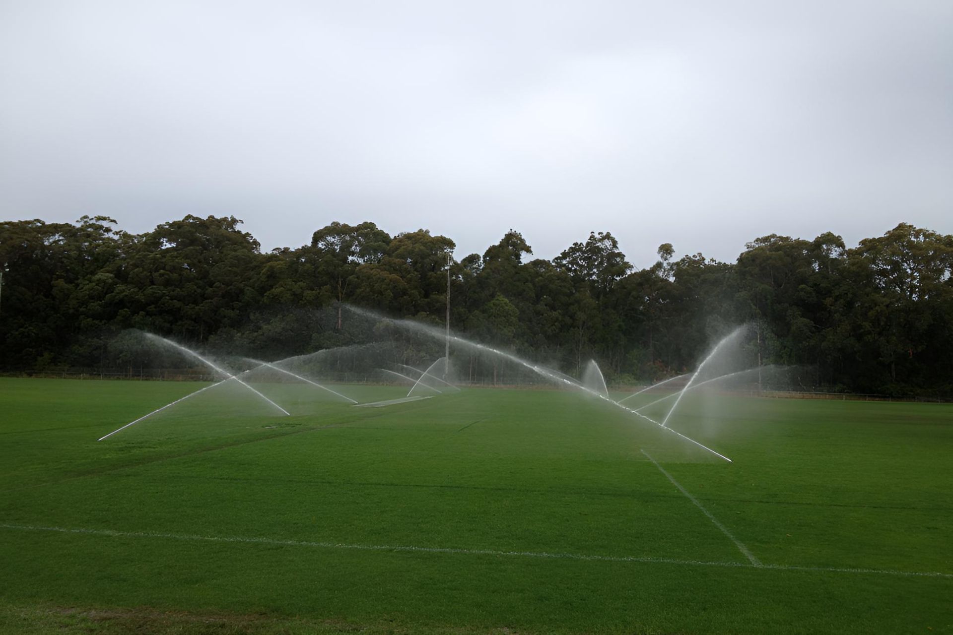 A Soccer Field With Sprinklers Spraying Water on It — Sweeney's Pumps & Irrigation In Medowie, NSW