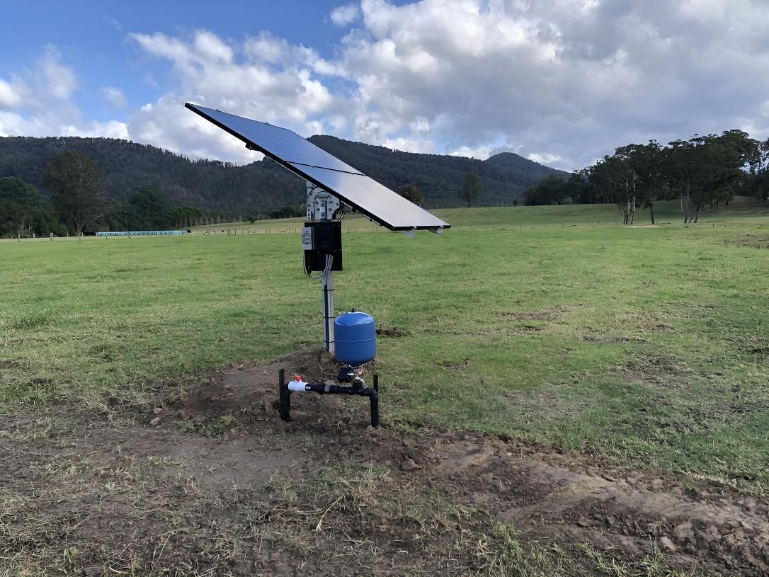 A Solar Panel is Sitting in the Middle of a Grassy Field — Sweeney's Pumps & Irrigation In Medowie, NSW
