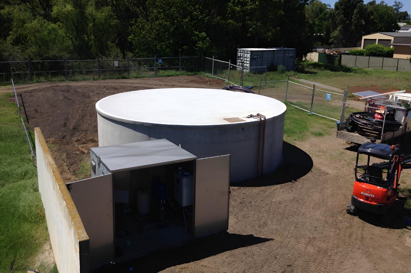 An Aerial View of a Large Concrete Tank in a Field — Sweeney's Pumps & Irrigation In Medowie, NSW