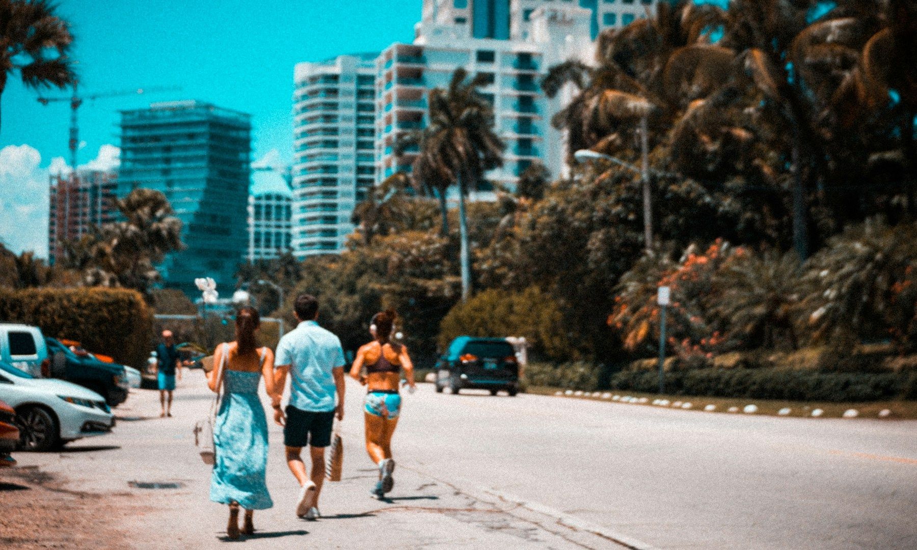 A group of people are walking down a street in a city.