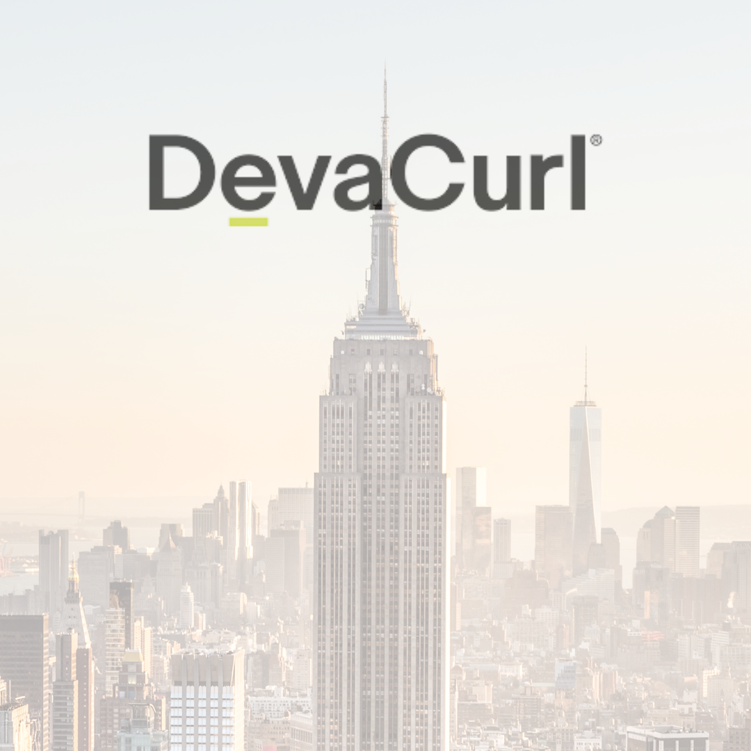 A picture of a city skyline with a very tall building in the foreground.