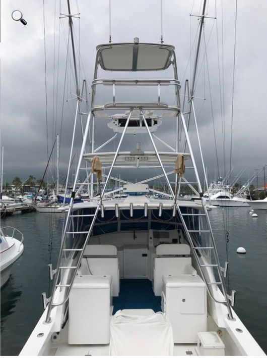 A boat is docked in a marina with other boats