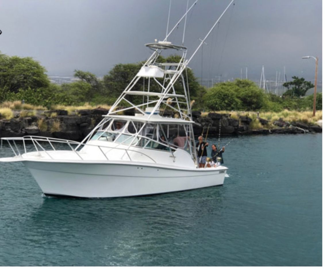 A white boat is floating on top of a body of water.