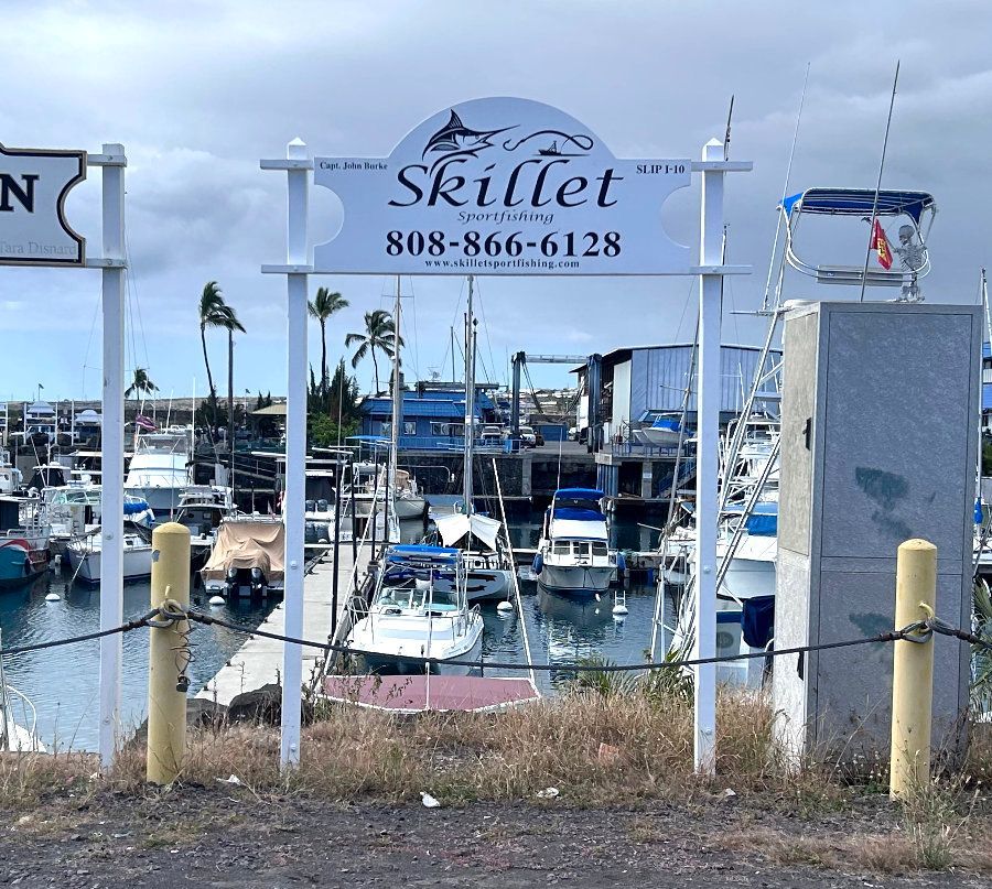 A sign that says skillet in front of a marina