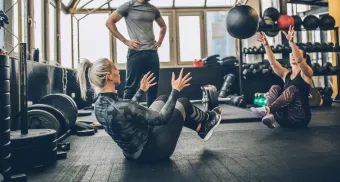 A group of people are doing exercises in a gym.