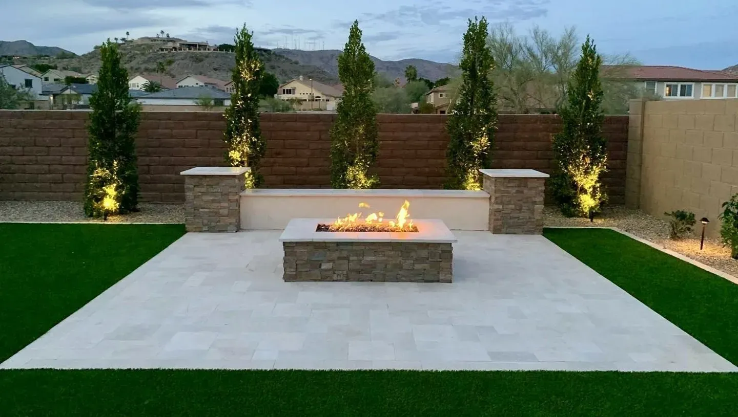 There is a fire pit in the middle of the lawn.