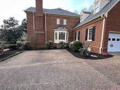 A large brick house with a driveway and a garage.