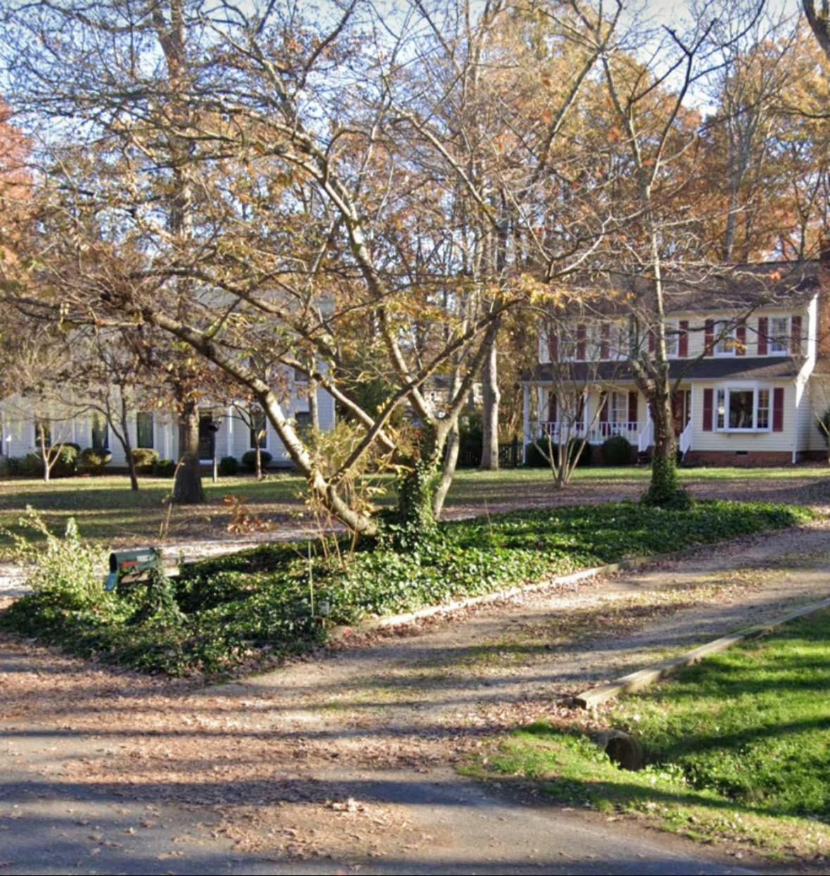 A house with a lot of trees in front of it