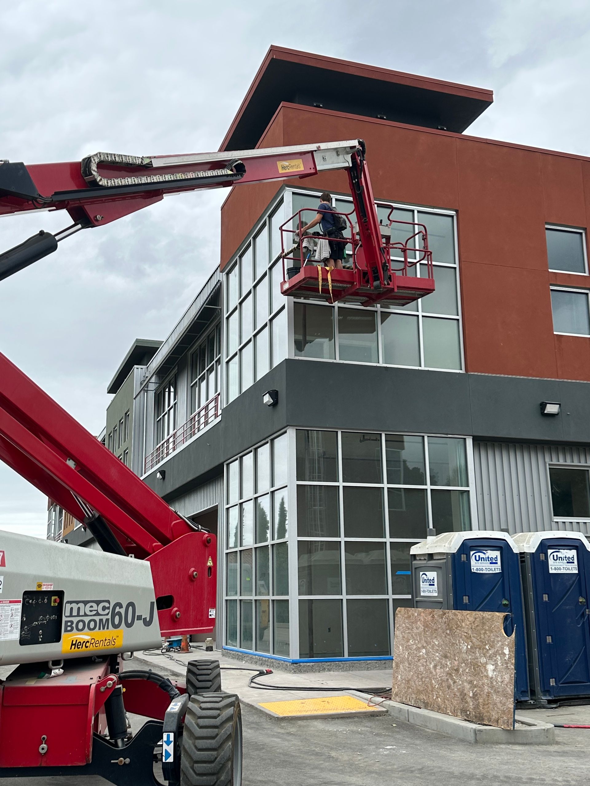 A round building with a lot of windows and a tree in the background
