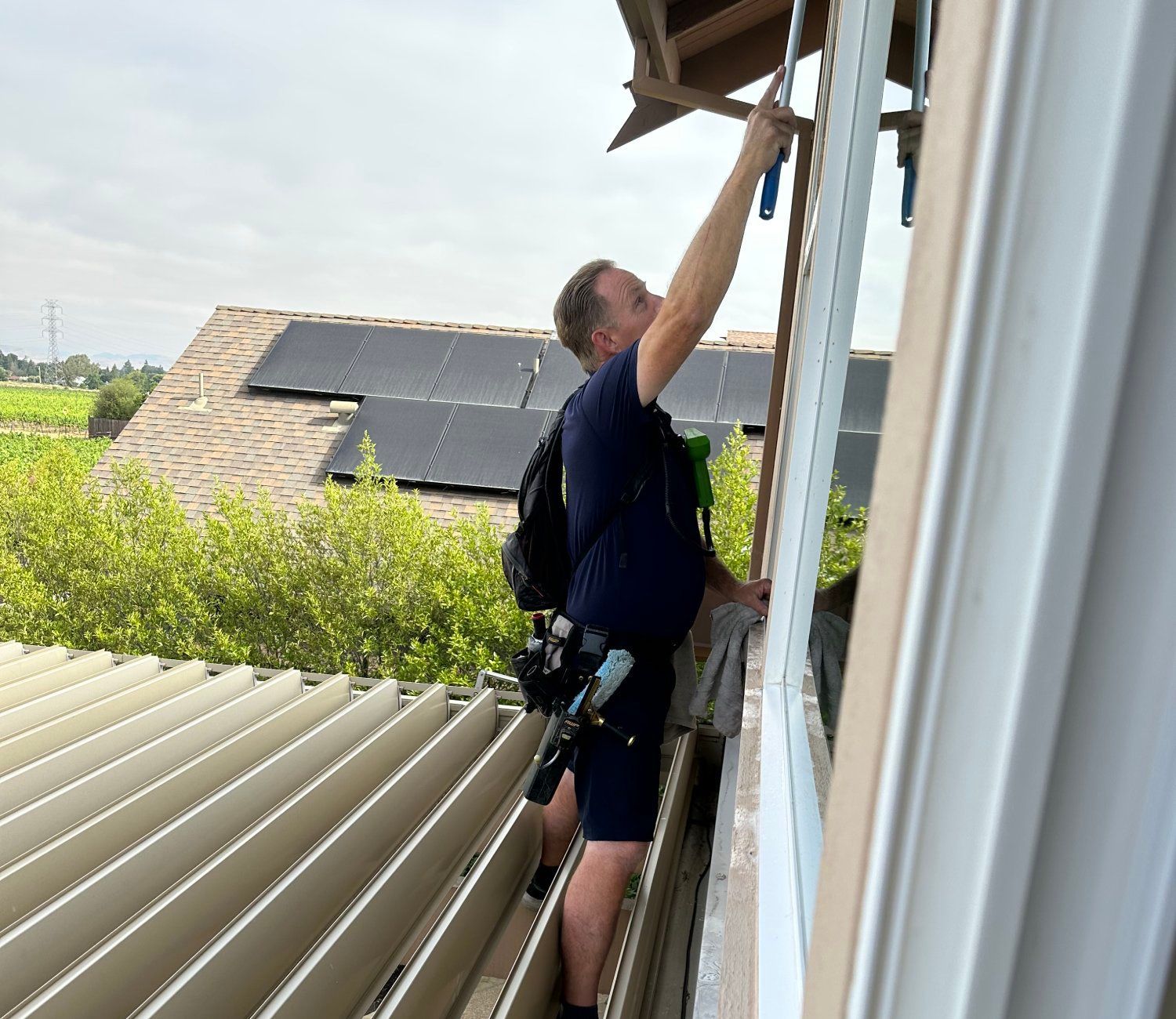 A man is working on the side of a building.