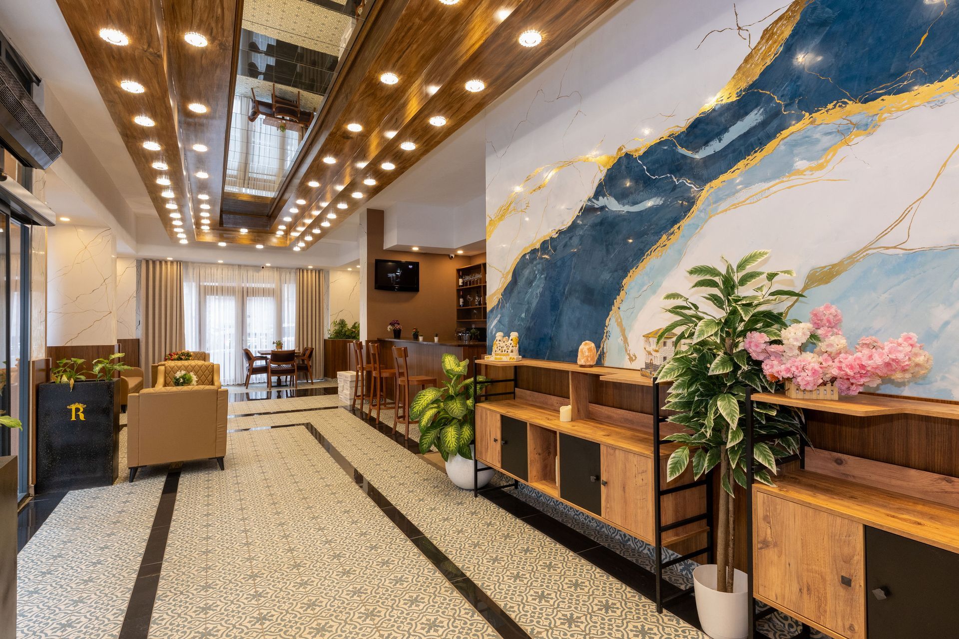 Istanbul By Rich Hotel | Lobi | Hotel lobby with wood accents, large art wall, and potted plants.